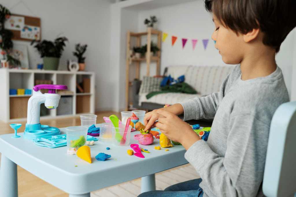 Child in a child-centred play therapy session, moulding colourful playdough.